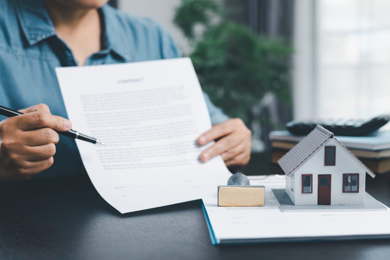 Signing real estate contract at desk